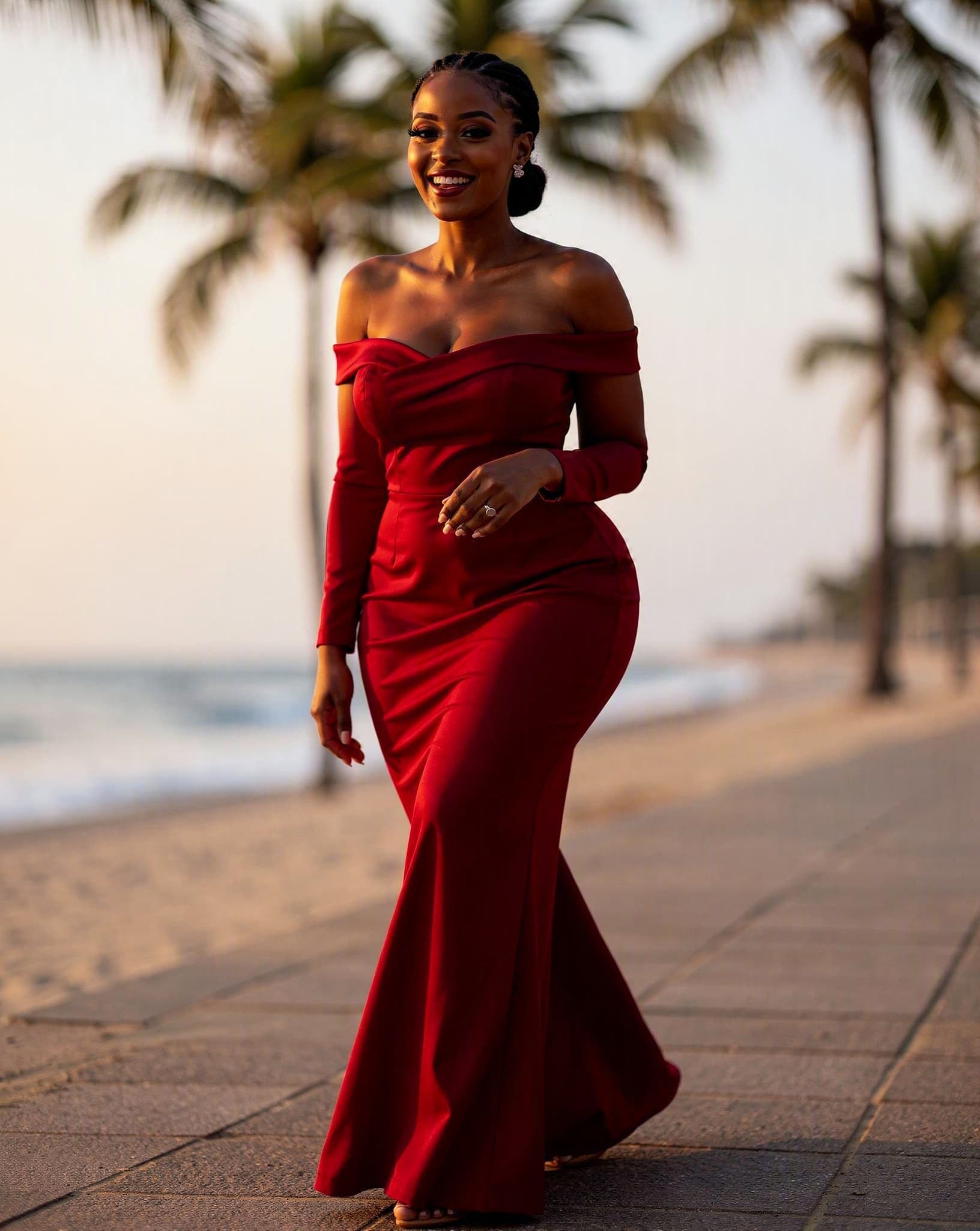 Lindiwe in a red off-shoulder gown on the Durban beachfront — a No Safe Word character